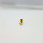 Small crescent 18K nose pin gold placed on a white background showing delicate detailing