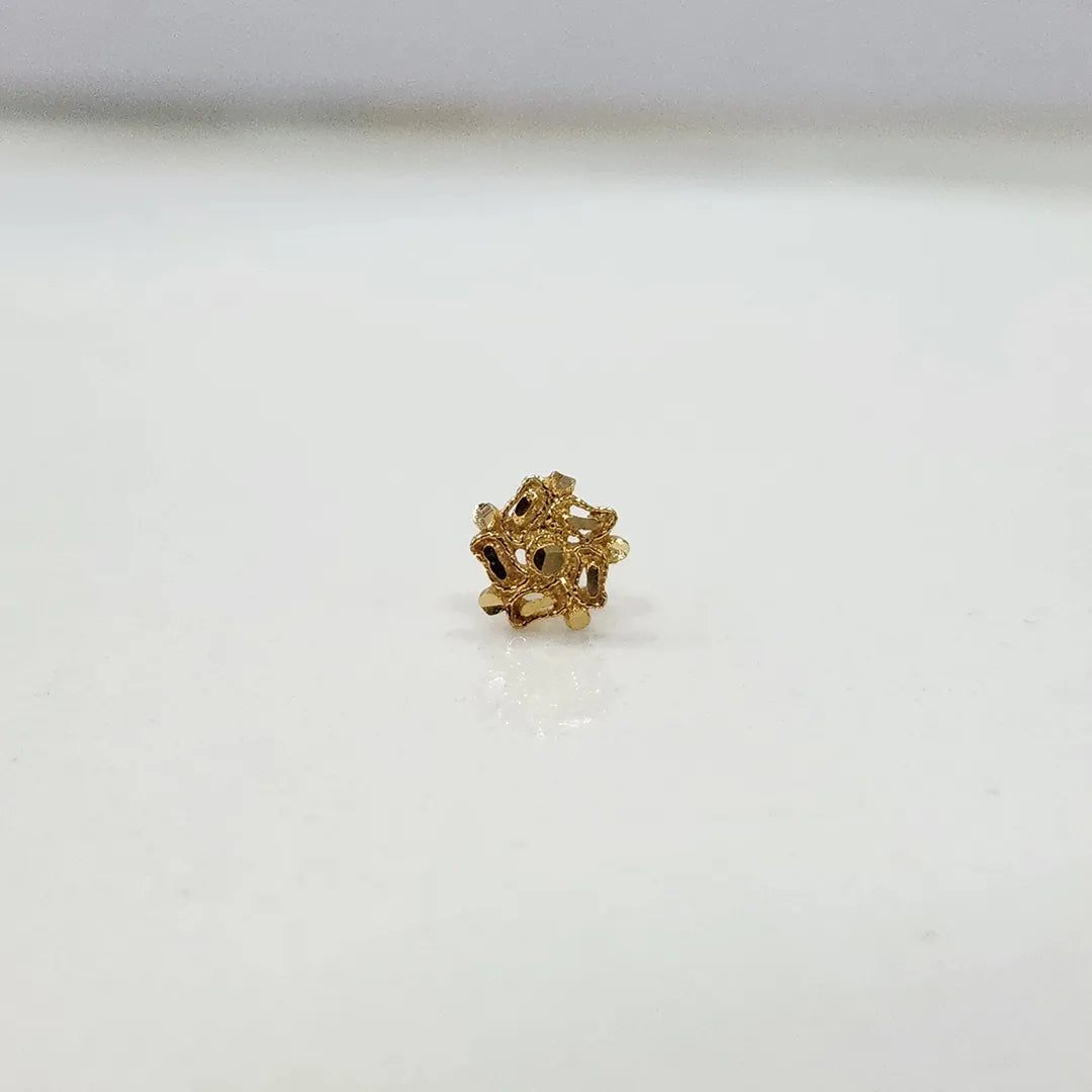 Side view of a floral 18K nose pin gold on a white background showing fine detailing and polished finish