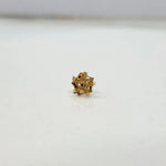 Side view of a floral 18K nose pin gold on a white background showing fine detailing and polished finish
