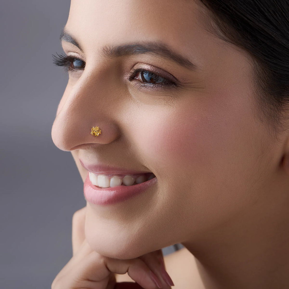 Woman wearing a delicate floral 18K nose pin gold showcasing an elegant everyday and festive look