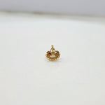 Close up of crescent shaped gold nose pin design on white background highlighting fine texture
