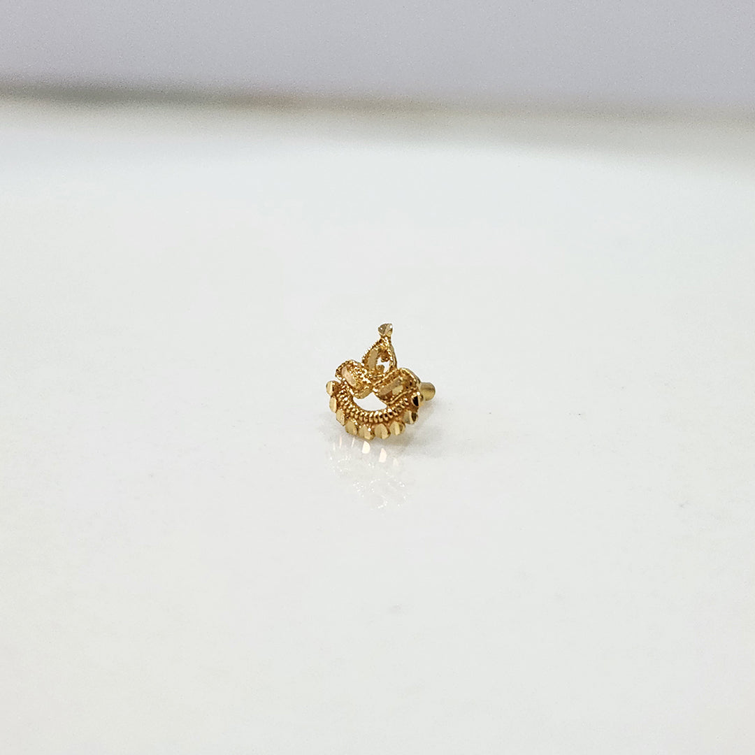 Side angle view of handcrafted 18k crescent gold nose pin design featuring traditional indian artistry