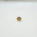 Side view of a tiny 18K nose pin gold on a clean white surface highlighting its lightweight and minimal design