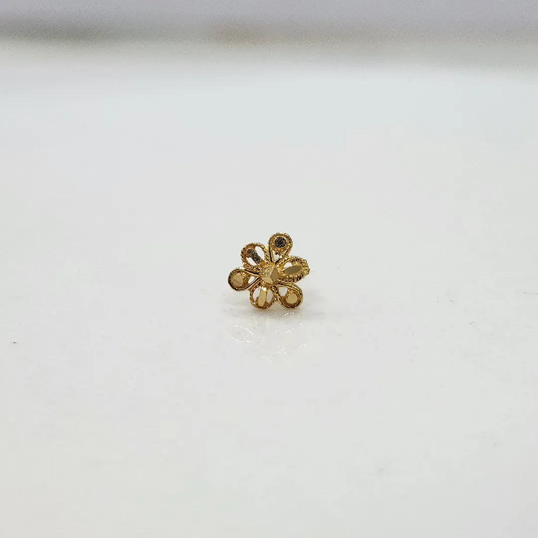 Front view of a small floral 18K nose pin gold placed on a white background highlighting its compact size and neat finish
