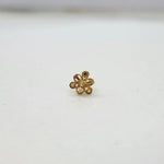 Front view of a small floral 18K nose pin gold placed on a white background highlighting its compact size and neat finish