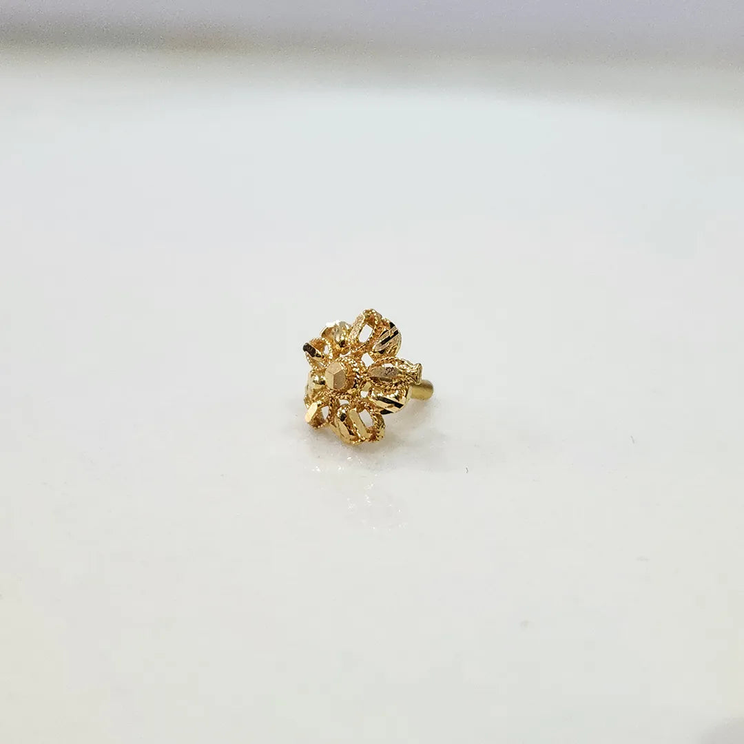 Front view of a small floral 18K gold nose pin on a white background showing its fine petal design
