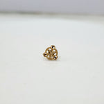 Close up of triangular floral gold nose pin design on white background elegant and minimal for women