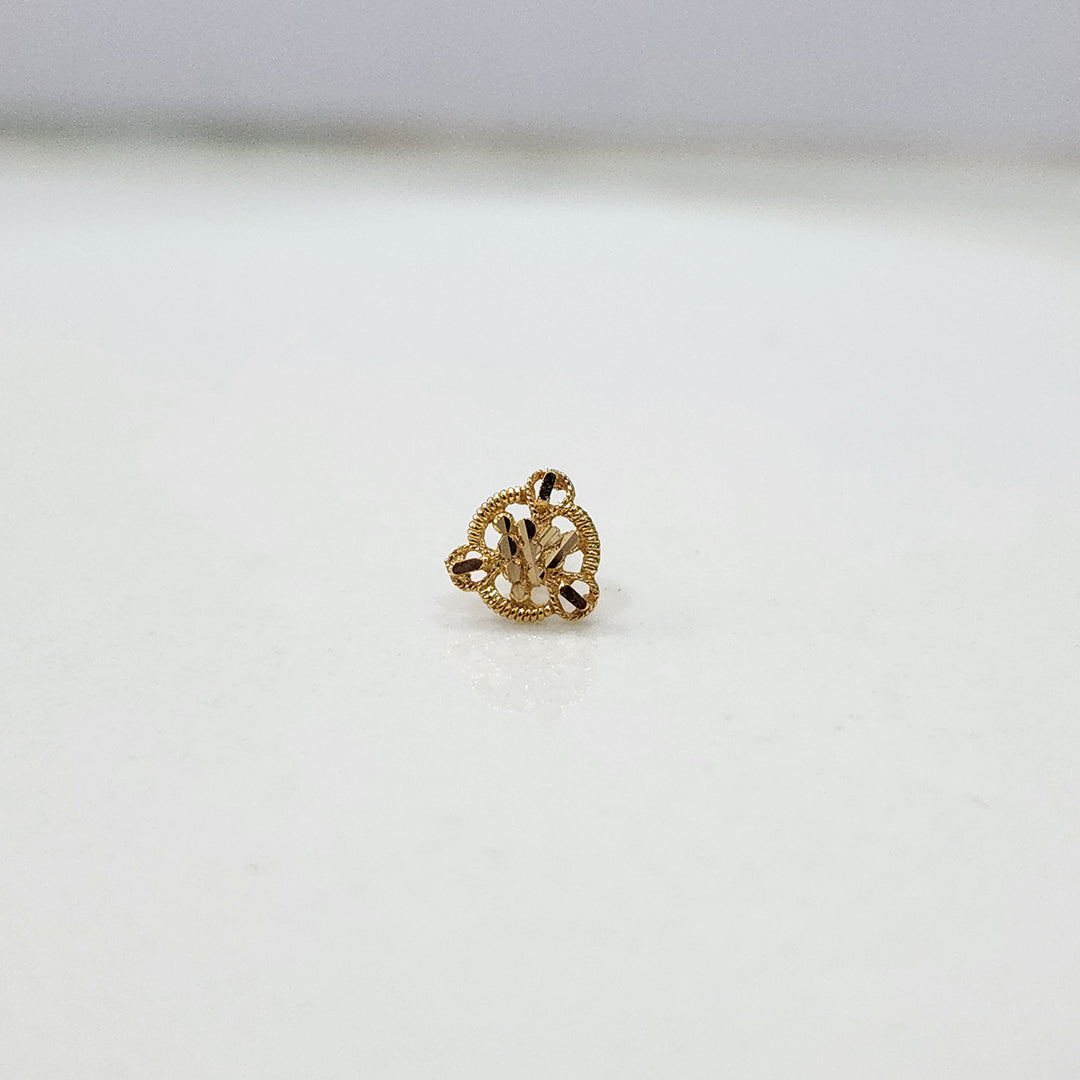 Close up of triangular floral gold nose pin design on white background elegant and minimal for women