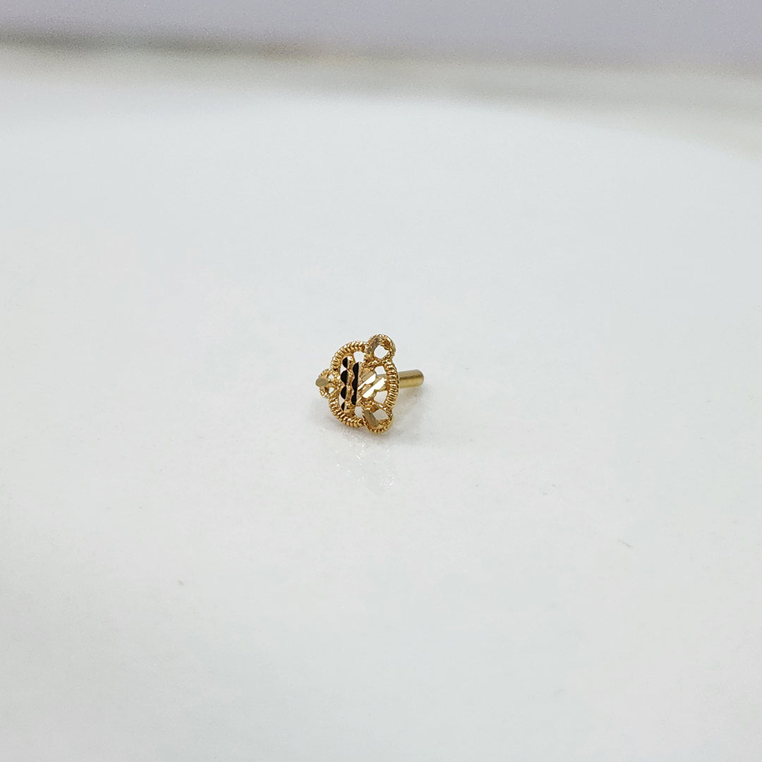 Side view of handcrafted 18k gold nose pin design with fine traditional floral texture