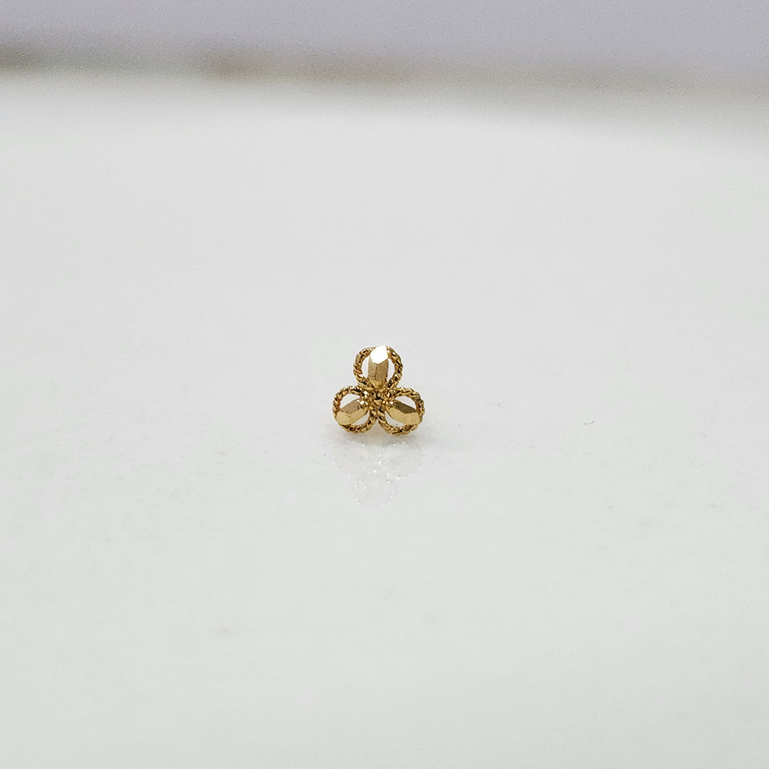 Close up of three petal gold nose pin design on white background perfect for elegant modern jewellery style