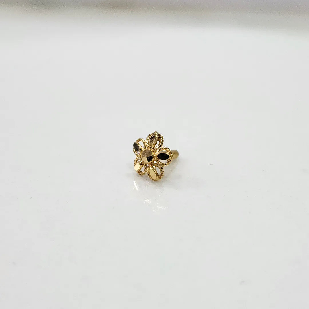 Front view close up of a small 18K nose pin gold on a white background highlighting fine detailing