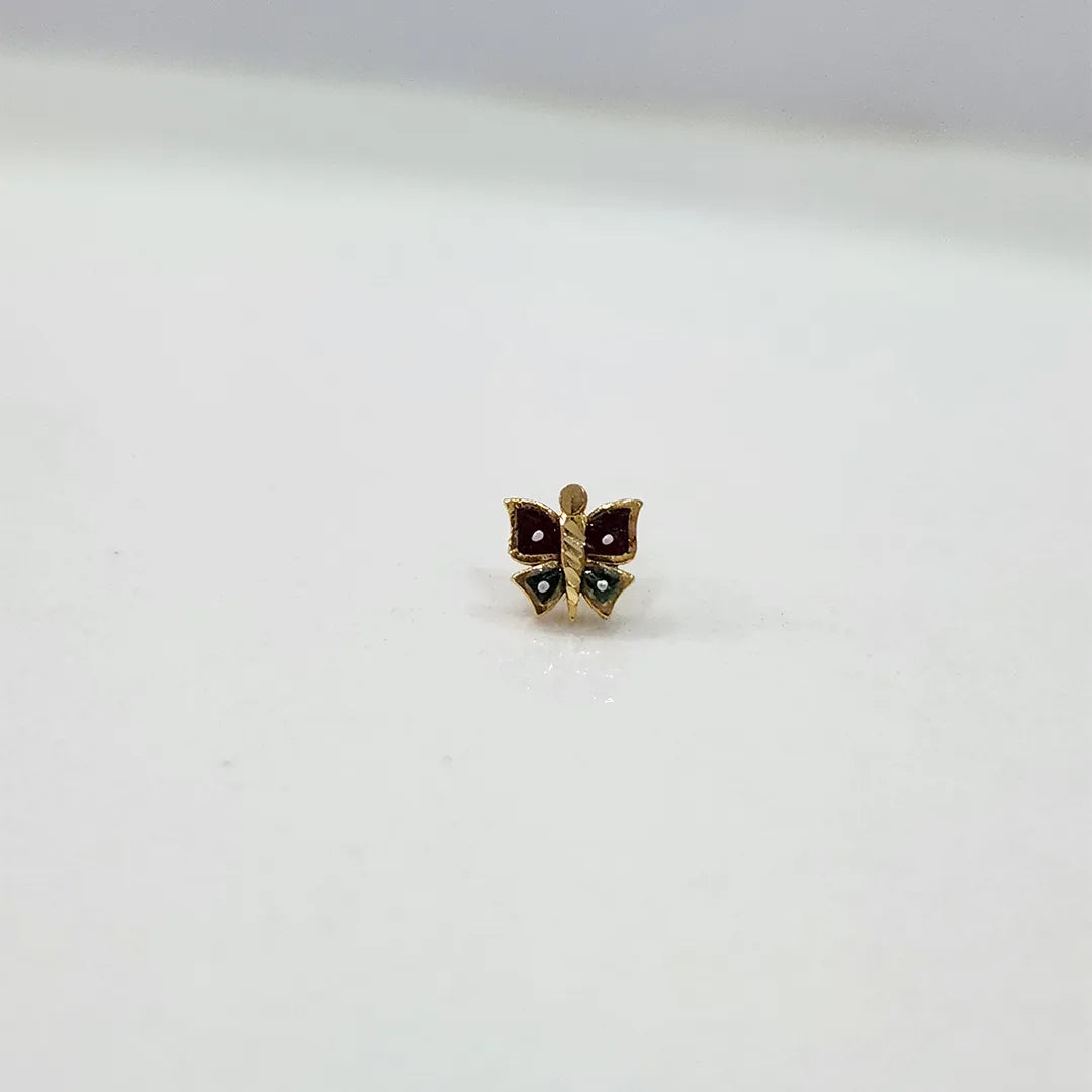 Front view of tiny butterfly-shaped 18K gold nose pin on a white background showing its colourful accents