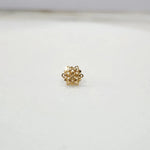 Front view of a small floral 18K nose pin gold placed on a white background highlighting its compact and delicate design