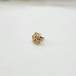 Side view of a floral 18K nose pin gold on a white surface showing fine detailing and polished finish