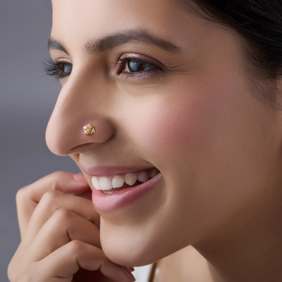 Woman wearing a floral 18K nose pin gold showcasing an elegant everyday look with subtle traditional styling