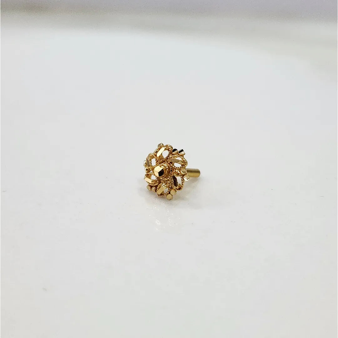 Side view of a tiny 18K nose pin gold on a white surface displaying its compact size and polished finish