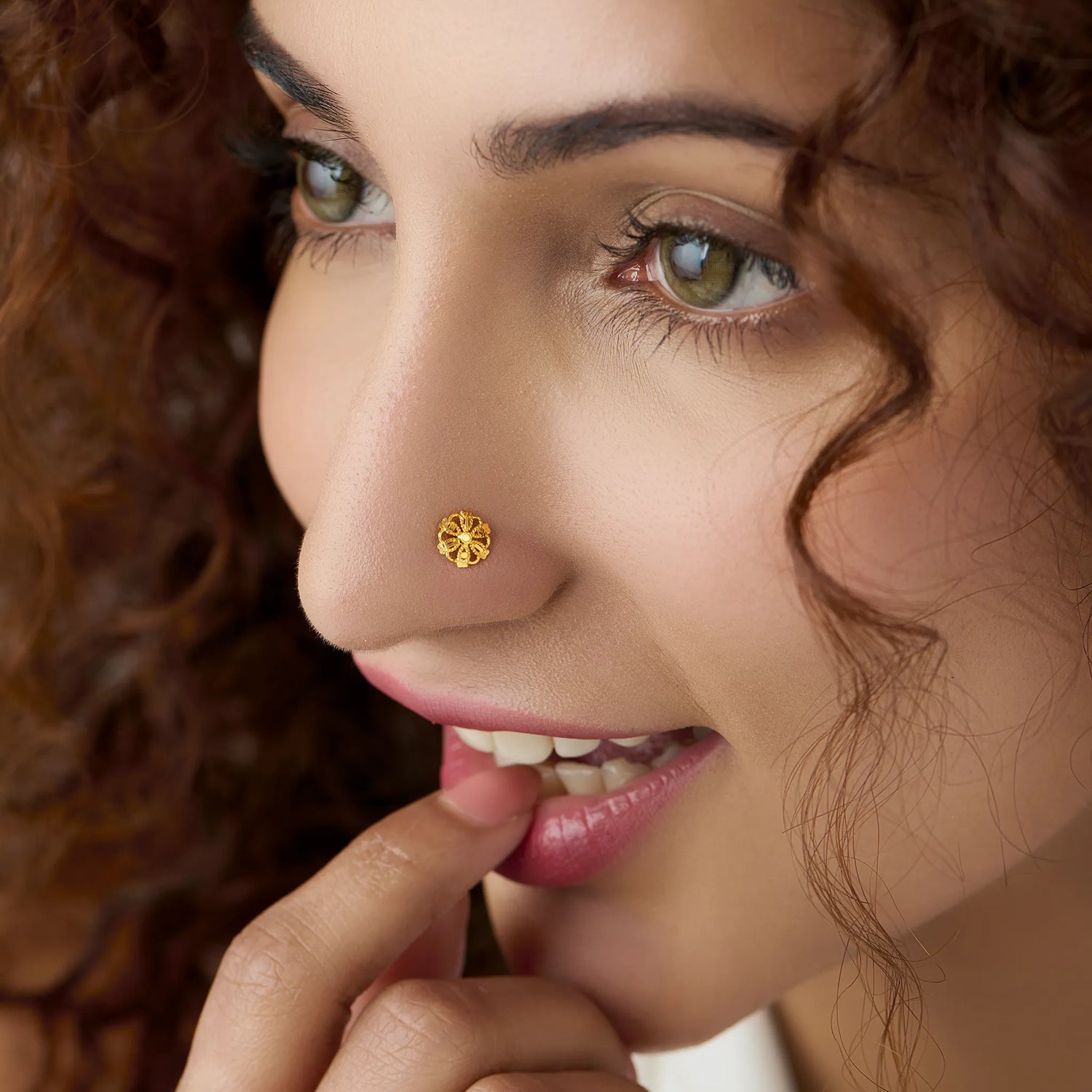 Woman wearing a delicate 18K nose pin gold showcasing an elegant everyday ethnic look