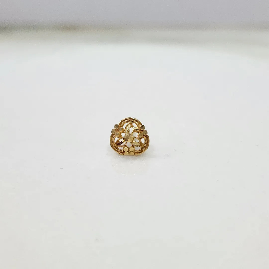 Front view of a small 18K nose pin gold on a clean white background showing its compact floral detailing
