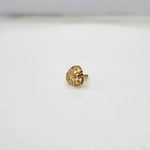 Side view of a tiny 18K nose pin gold placed on a white surface highlighting its polished finish and fine craftsmanship