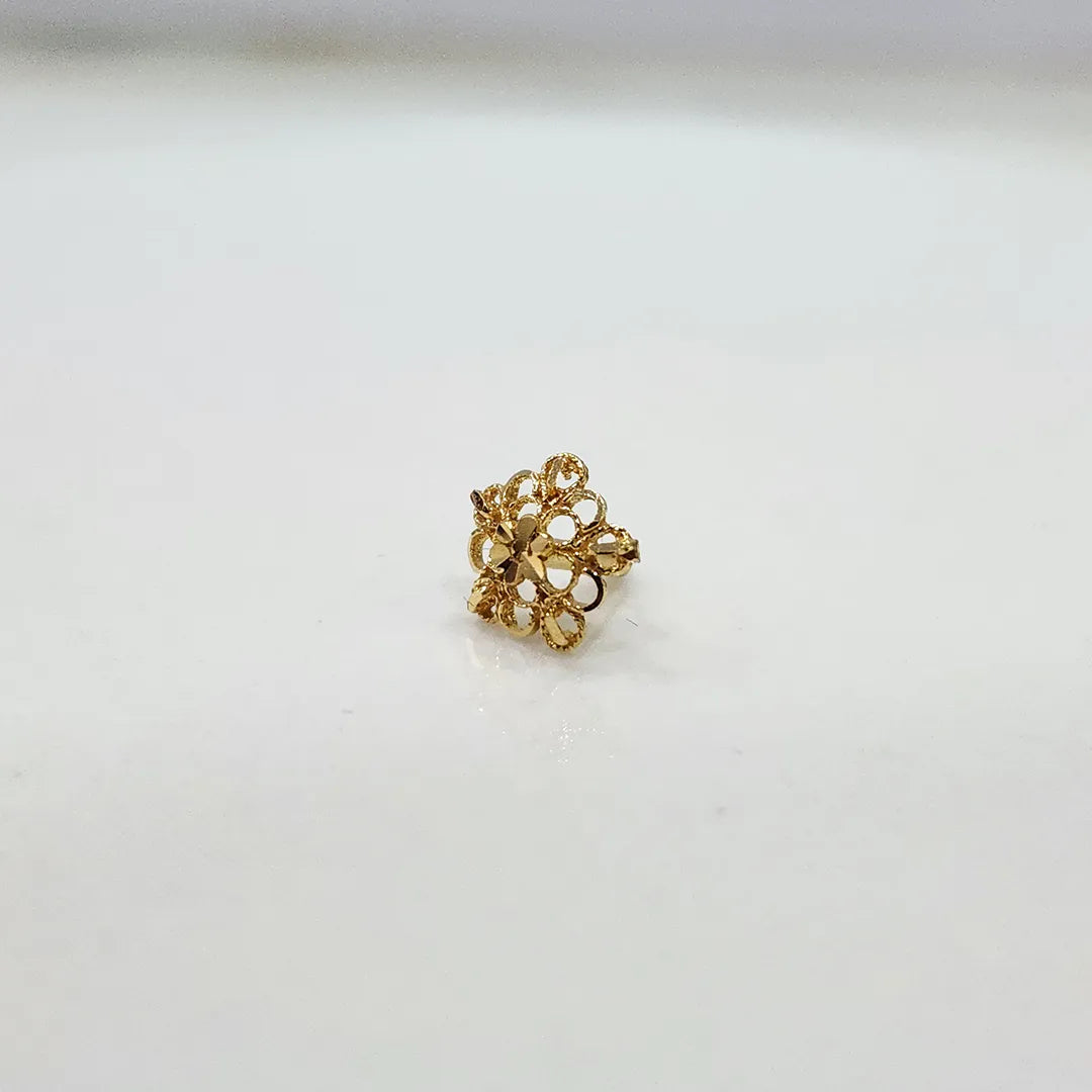 Front view of a small floral 18K nose pin gold placed on a white background showing fine detailing