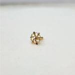 Side view of a tiny floral 18K nose pin gold on a white surface highlighting its compact size and polished finish