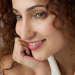 Woman wearing a delicate 18K nose pin gold showcasing a soft elegant everyday look
