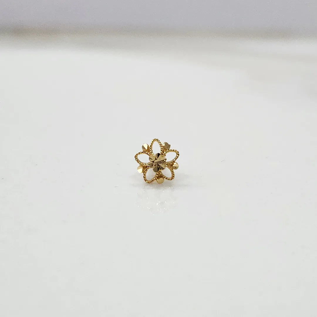 Small floral 18K gold nose pin on a white background displaying its fine craftsmanship