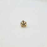 Front view of an 18K gold floral nose pin capturing its symmetrical flower-inspired design