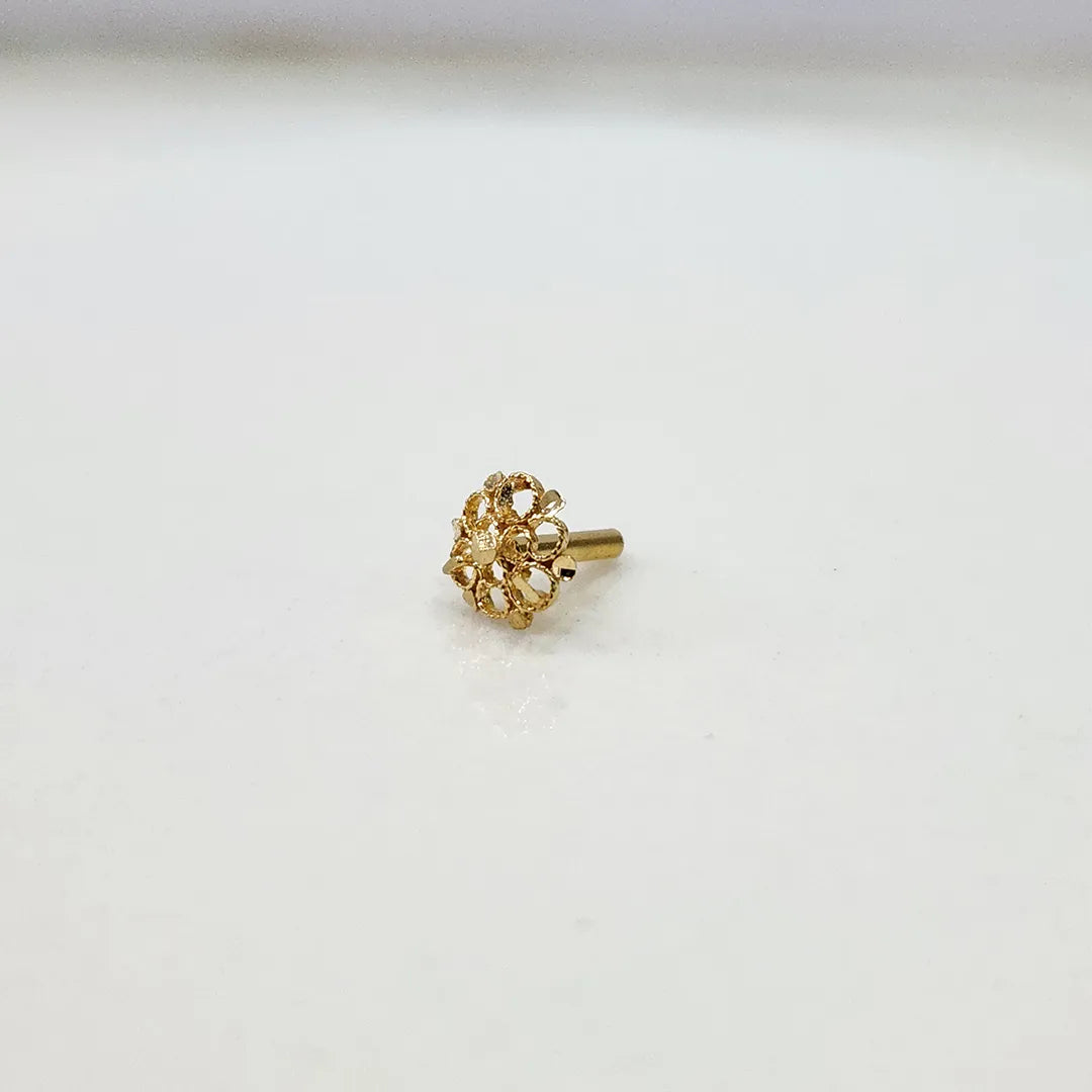 Front view of a small 18K gold floral nose pin placed on a white background displaying its fine detailing