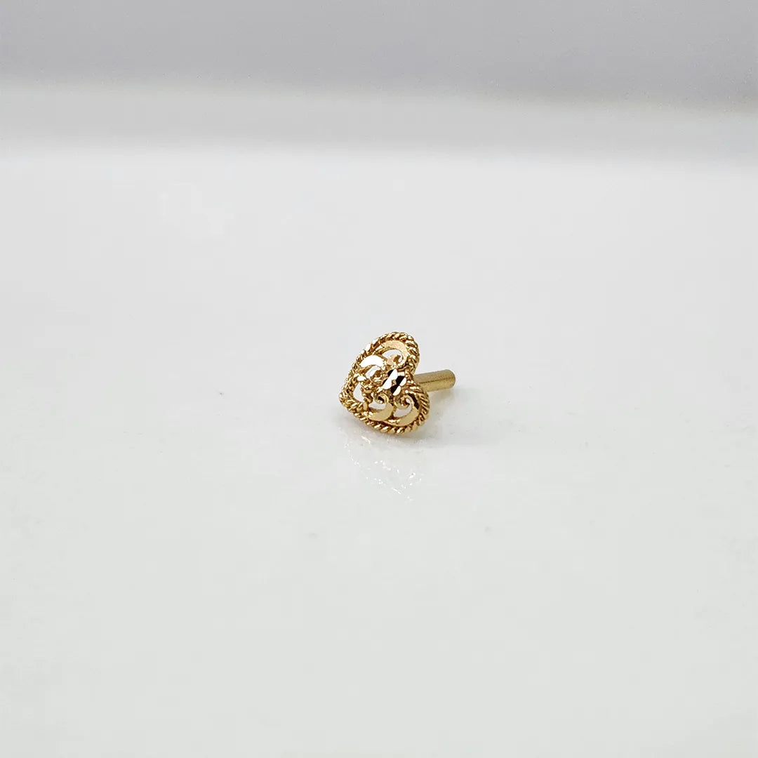 Front view of tiny 18K heart gold nose pin on a white background showing fine detailing