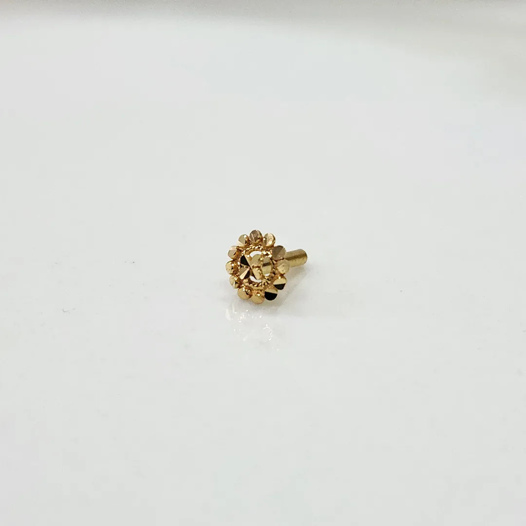 Front view of tiny 18K floral gold nose pin on a white background showing fine craftsmanship