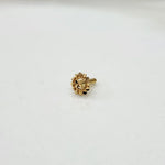 Front view of tiny 18K floral gold nose pin on a white background showing fine craftsmanship