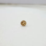 Front view of tiny 18K floral gold nose pin on a white background showing its fine design