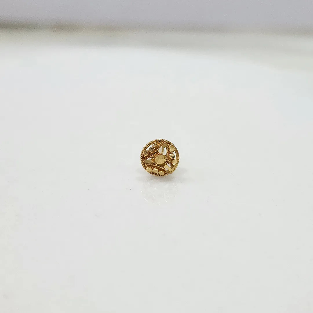 Front view of tiny 18K floral gold nose pin on a white background showing its fine design