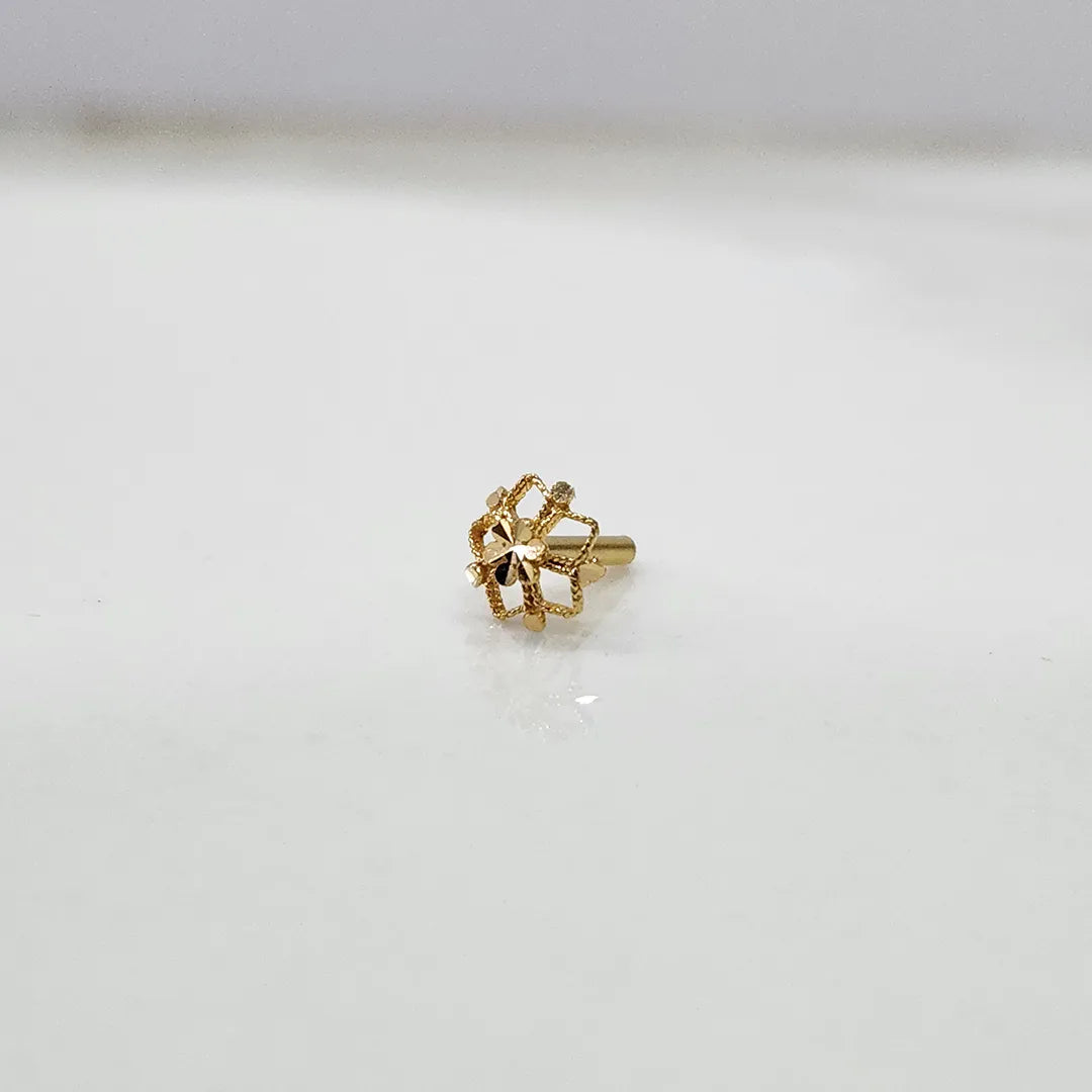 Front view of a tiny 18K gold floral nose pin on a white background showing its fine petal design