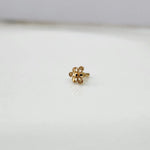 Front view of a small 18K nose pin gold placed on a clean white background highlighting delicate craftsmanship
