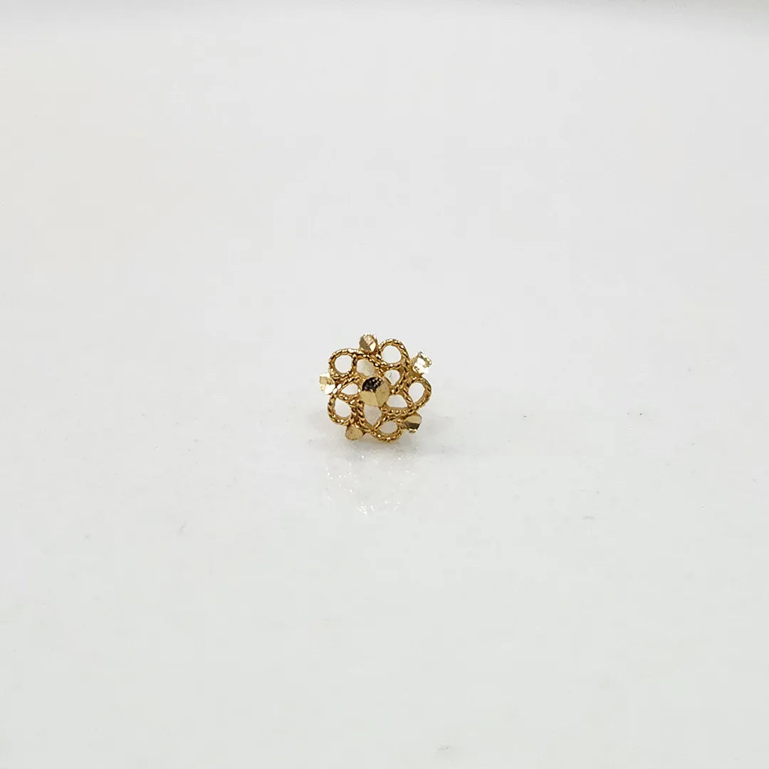 Side view of a tiny 18K nose pin gold on a white surface highlighting its compact size and smooth finish