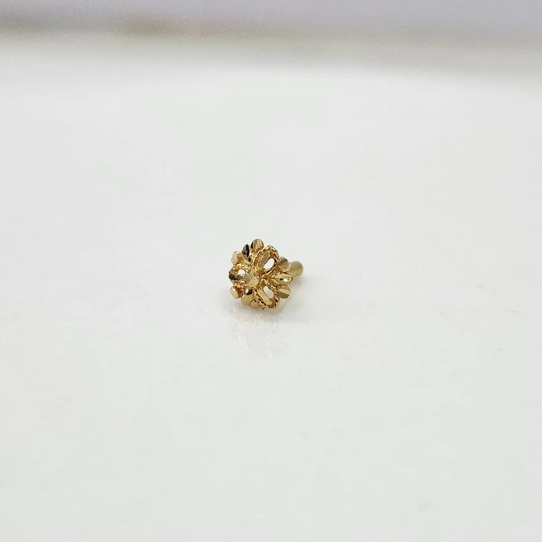 Front view of tiny 18K floral gold nose pin on a white background showing its fine design