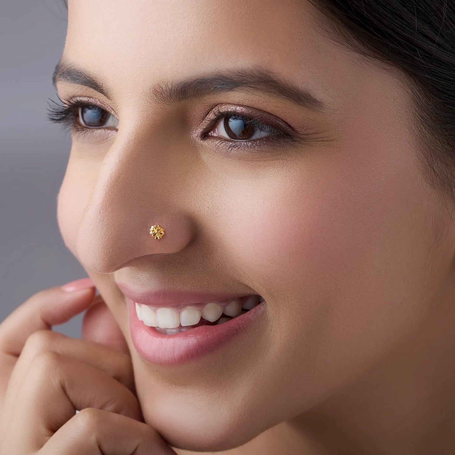 Woman wearing a delicate 18K floral gold nose pin highlighting an elegant everyday style