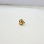 Side angle view of the round floral inspired 18K gold nose pin on a white background highlighting the secure post and back finish