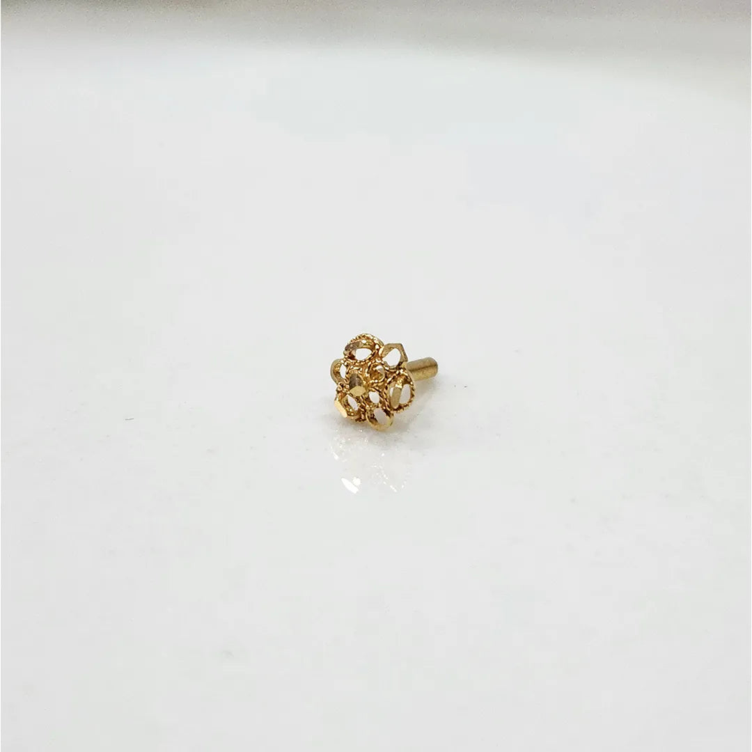 Front view of tiny 18K floral gold nose pin on a white background showing its fine detailing