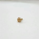 Front view of tiny 18K floral gold nose pin on a white background showing its fine detailing