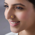 Woman wearing elegant gold nose pin design highlighting delicate floral motif for everyday elegance