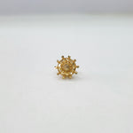 Close up of handcrafted floral gold nose pin design on white background ideal for indian women