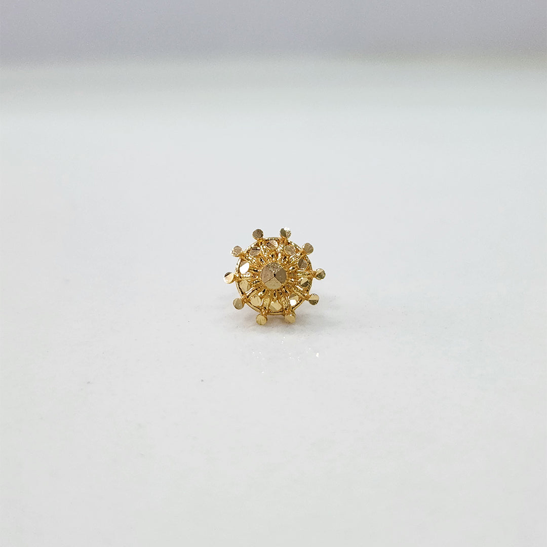 Close up of handcrafted floral gold nose pin design on white background ideal for indian women