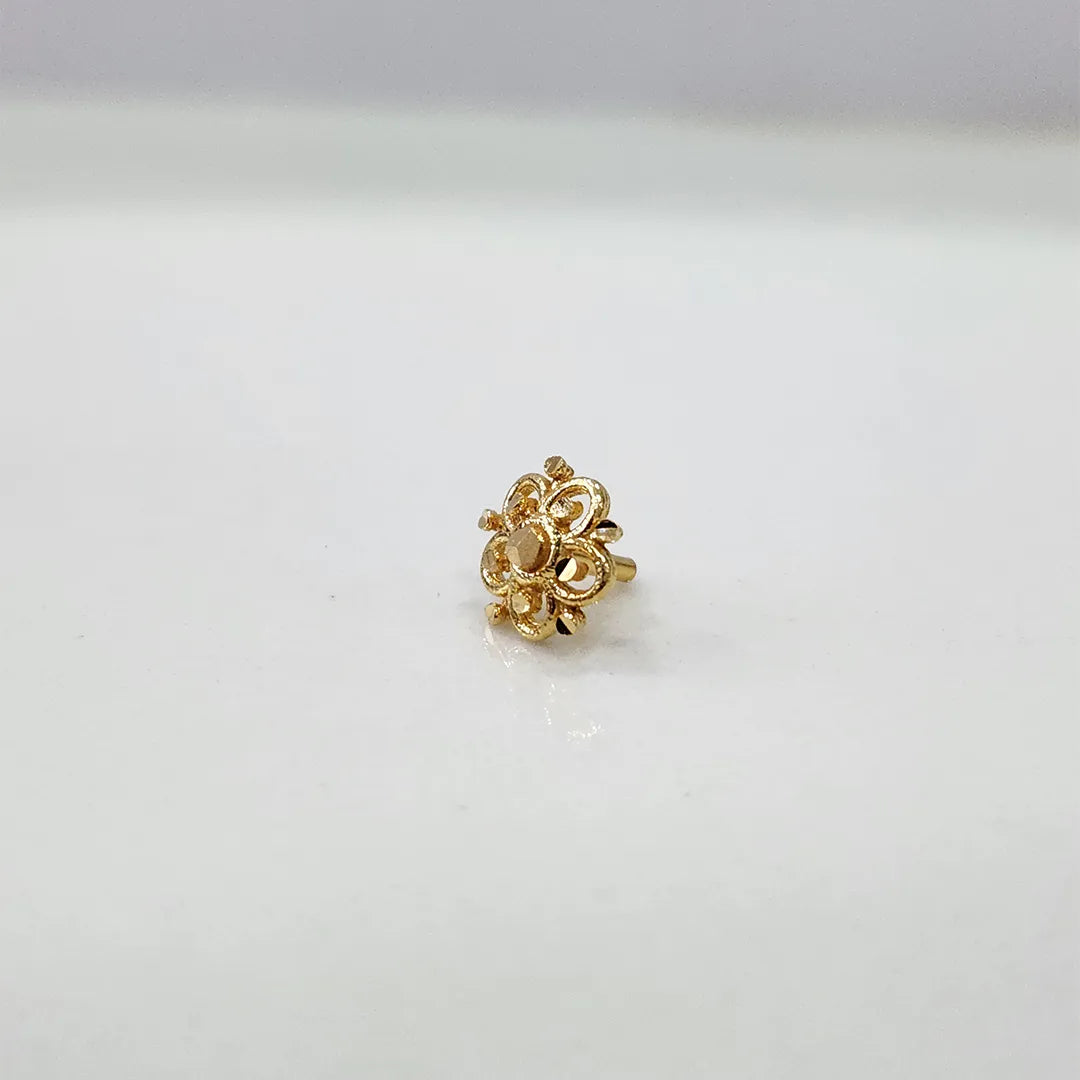 Tiny floral 18K gold nose pin displayed on a white background showcasing its fine craftsmanship