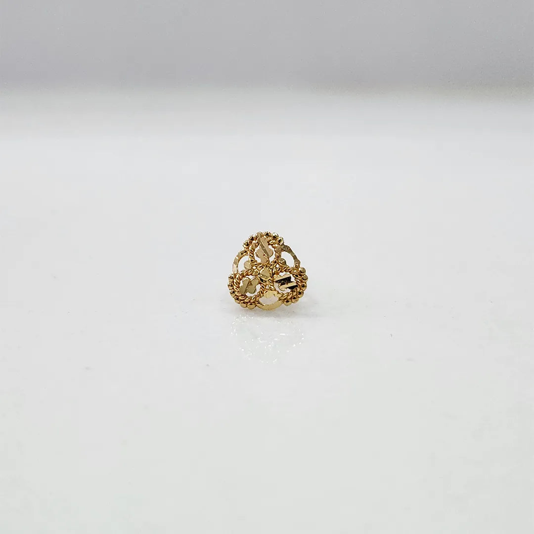 Front view of floral 18K gold nose pin on a white surface emphasizing the compact and symmetrical design