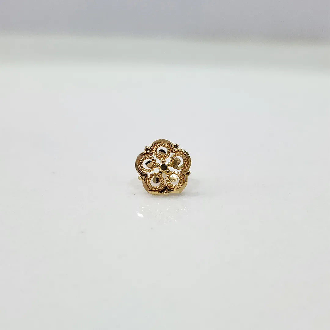 Close-up of floral 18K nose pin gold on a clean surface highlighting its intricate design