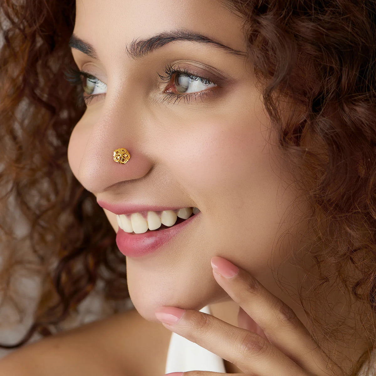 Woman wearing floral 18K nose pin gold showcasing an elegant everyday ethnic look