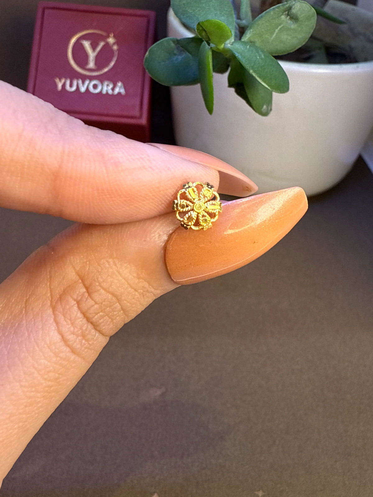 Woman smiling while wearing a delicate floral 18K gold nose pin showcasing subtle elegance and everyday styling